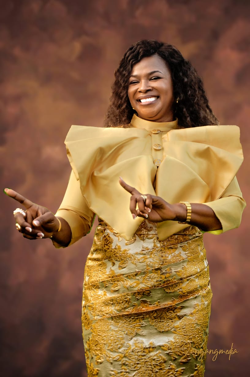 Gold brocade dress with sculptural bow collar detail