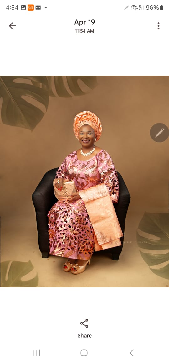 Pink and gold lace gown with matching gele